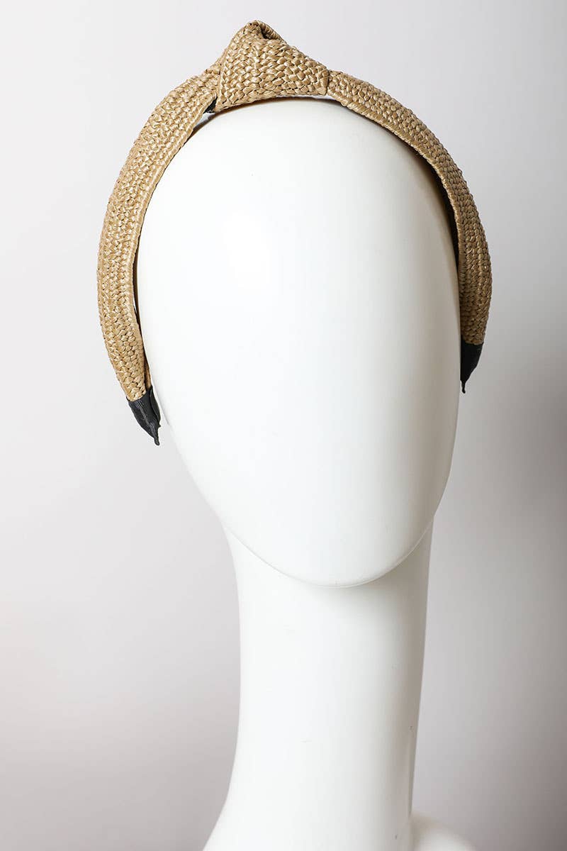 Beige woven headband on a mannequin head against a white background