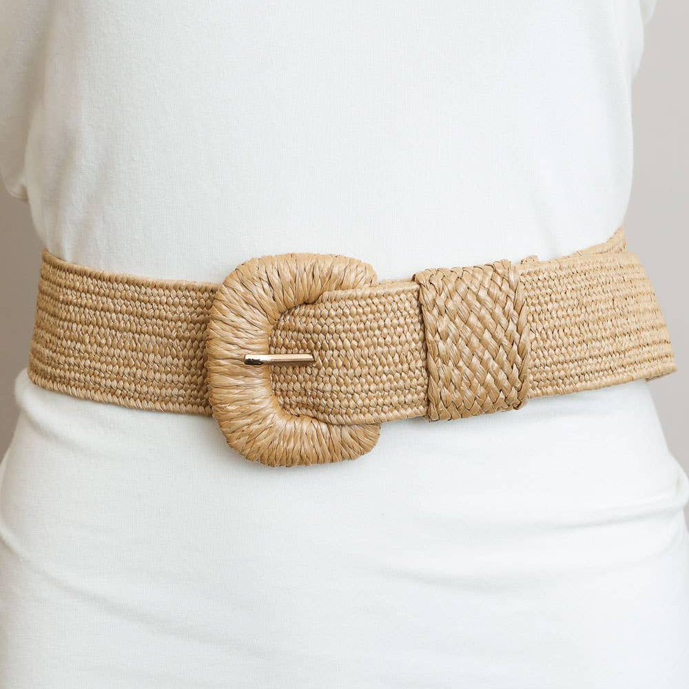Beige woven belt with a large round buckle on a white outfit