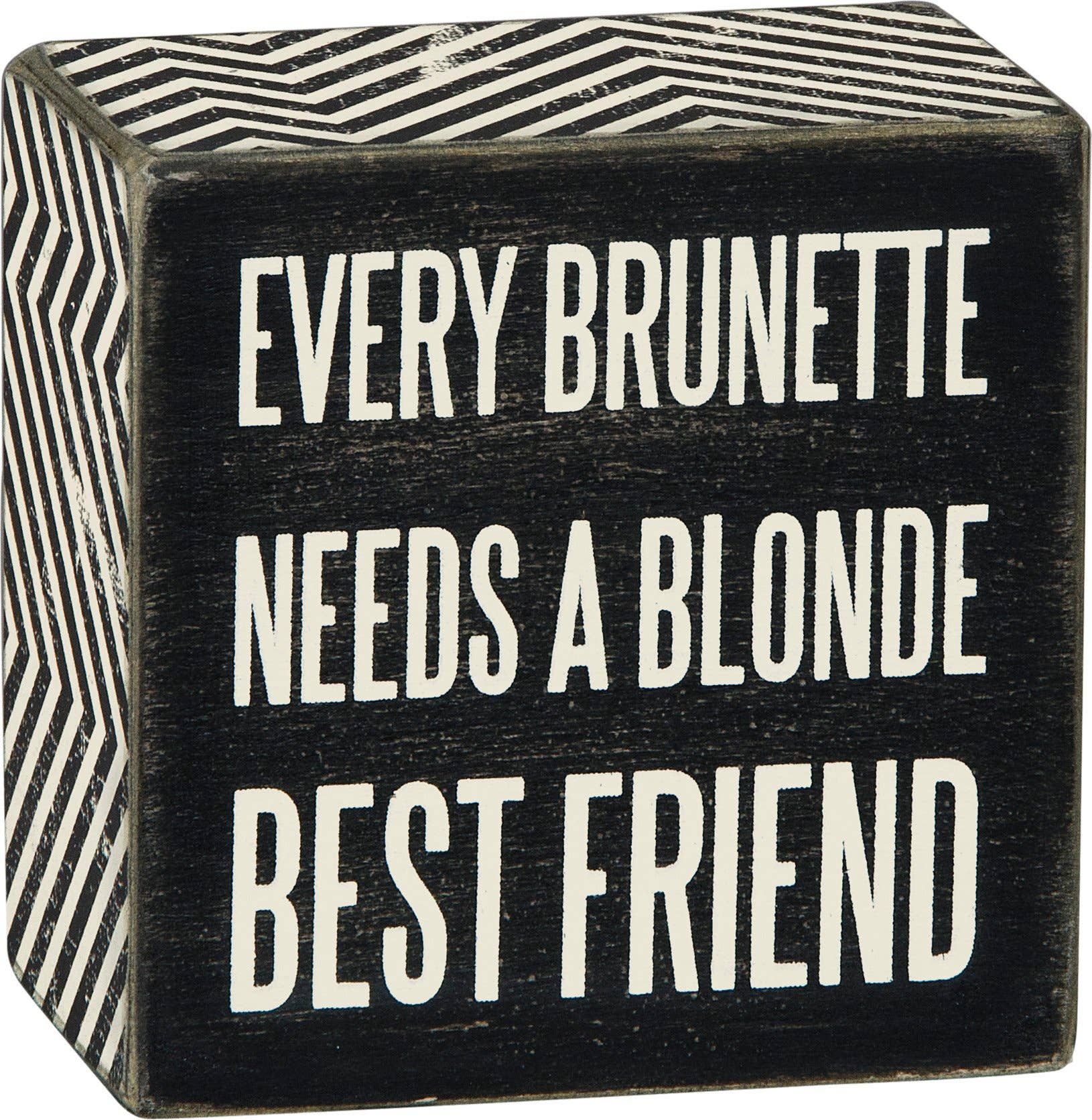 Black wooden block with white text 'Every Brunette Needs a Blonde Best Friend' on a black background