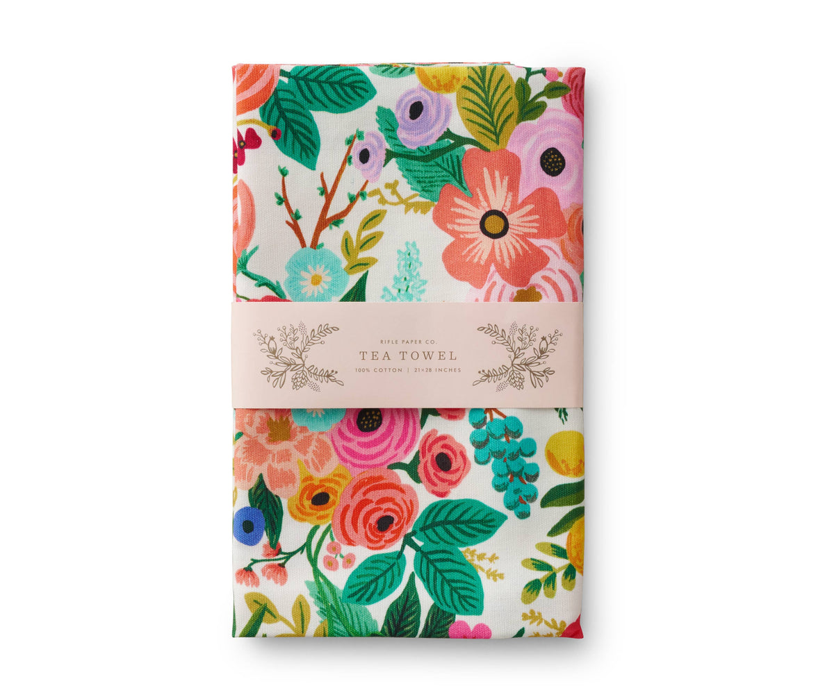 Floral patterned tea towel packaging on a white background